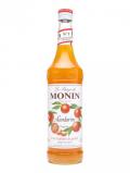 A bottle of Monin Tangerine Syrup