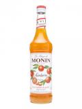 A bottle of Monin Tangerine Syrup